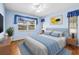 Stylish bedroom with blue walls, ceiling fan, window with curtains and a cozy bed setting at 1908 Canterbury Ln # 28, Sun City Center, FL 33573