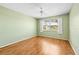 Bedroom featuring hardwood floors, a ceiling fan, and a window overlooking the neighborhood at 1908 Canterbury Ln # 28, Sun City Center, FL 33573