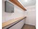 Empty walk-in closet with an alarm system box and wooden shelving at 1908 Canterbury Ln # 28, Sun City Center, FL 33573