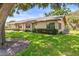 Charming one-story home with well-maintained landscaping, green lawn, and a mature tree at 1908 Canterbury Ln # 28, Sun City Center, FL 33573
