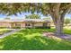 Charming one-story home with well-maintained landscaping and a lush green lawn at 1908 Canterbury Ln # 28, Sun City Center, FL 33573