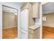 Kitchen featuring a white refrigerator, granite countertops and tan cabinets near dining area entrances at 1908 Canterbury Ln # 28, Sun City Center, FL 33573