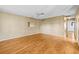 Spacious room with wood floors, ceiling fan, and views into the hall at 1908 Canterbury Ln # 28, Sun City Center, FL 33573