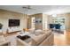 Comfortable living room with hardwood floors, sofa, and access to a dining area at 1908 Canterbury Ln # 28, Sun City Center, FL 33573