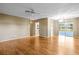 Open concept living room featuring wood floors, sliding glass doors, and ceiling fan at 1908 Canterbury Ln # 28, Sun City Center, FL 33573