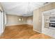 Open-concept living room with hardwood floors, leading into the kitchen and dining area at 1908 Canterbury Ln # 28, Sun City Center, FL 33573