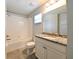Bathroom showcasing granite countertops, white cabinetry, tile floors, and a bathtub/shower combo at 19200 Roseate Dr, Lutz, FL 33558
