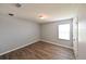 Standard bedroom featuring neutral paint, wood-look flooring, a window, and a ceiling light at 19200 Roseate Dr, Lutz, FL 33558