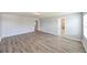 Spacious bedroom with wood-look floors, neutral walls, multiple doorways, and great natural light at 19200 Roseate Dr, Lutz, FL 33558