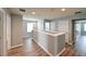 Hallway showcasing neutral walls and wood flooring, offering a modern and spacious feel at 19200 Roseate Dr, Lutz, FL 33558