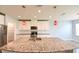 Modern kitchen featuring an island with granite countertop, stainless steel appliances, and white cabinets at 19200 Roseate Dr, Lutz, FL 33558