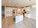 Open kitchen showcasing tile flooring, white cabinets, stainless steel appliances, and a granite-topped island at 19200 Roseate Dr, Lutz, FL 33558