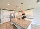 Modern kitchen with a granite island, stainless steel appliances, and white cabinetry at 19200 Roseate Dr, Lutz, FL 33558