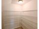 Walk-in pantry with metal shelving, providing ample storage for kitchen essentials at 19200 Roseate Dr, Lutz, FL 33558