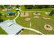 An aerial view of a well-equipped playground with various play structures and open green spaces at 19200 Roseate Dr, Lutz, FL 33558