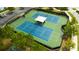 Aerial view of tennis courts featuring well-maintained blue and green surfaces, and a central gazebo at 19200 Roseate Dr, Lutz, FL 33558