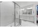 Sleek bathroom features a glass-enclosed shower, tile surround, and double sink vanity at 202 S Tampania Ave # 3, Tampa, FL 33609