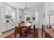 Bright dining area with classic sideboard, natural light, and a rustic patterned rug at 202 S Tampania Ave # 3, Tampa, FL 33609