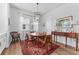 Cozy dining room with a wooden table, a patterned rug, and natural light from the windows at 202 S Tampania Ave # 3, Tampa, FL 33609