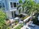 Aerial view of a home's private backyard featuring a seating area, outdoor grill and privacy fence surrounded by mature landscaping at 202 S Tampania Ave # 3, Tampa, FL 33609