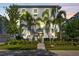 Attractive townhome with mature palm trees, manicured lawn, and a secure fenced yard at 202 S Tampania Ave # 3, Tampa, FL 33609