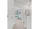 Hallway leads to a brightly lit Bedroom room with white crib and window view at 202 S Tampania Ave # 3, Tampa, FL 33609