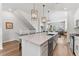 Open-concept kitchen featuring a large island, stainless steel appliances, and hardwood floors at 202 S Tampania Ave # 3, Tampa, FL 33609