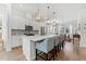 Bright, open kitchen boasts a spacious island with seating, stylish pendant lighting, and modern appliances at 202 S Tampania Ave # 3, Tampa, FL 33609