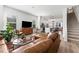 Open-concept living space with a large TV, stylish seating, and kitchen view at 202 S Tampania Ave # 3, Tampa, FL 33609