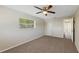 Bedroom with carpet flooring, a ceiling fan and closet at 204 Cove Ct, Clearwater, FL 33756
