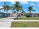 Charming single-story home with palm trees and a well-maintained front yard at 204 Cove Ct, Clearwater, FL 33756
