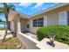 Inviting front porch with decorative stone accents, a charming light fixture, and manicured landscaping at 204 Cove Ct, Clearwater, FL 33756