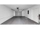 Spacious garage featuring a gray door, white walls, and sealed concrete flooring at 204 Cove Ct, Clearwater, FL 33756