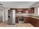Kitchen featuring stainless steel appliances, granite countertops, and wood cabinetry at 204 Cove Ct, Clearwater, FL 33756