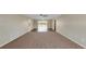 Spacious living room with carpet, tile flooring, and a view of the screened lanai at 204 Cove Ct, Clearwater, FL 33756