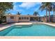 Backyard view featuring a private in-ground pool and a screened-in patio area at 204 Cove Ct, Clearwater, FL 33756