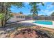 Relaxing backyard setting with a sparkling in-ground pool and comfortable lounging space at 204 Cove Ct, Clearwater, FL 33756