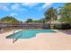 Secluded in-ground pool with a railing, perfect for enjoying sunny days and relaxation at 204 Cove Ct, Clearwater, FL 33756