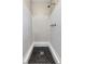 Tiled shower with black hexagon floor tiles and white wall paneling in bathroom at 204 Cove Ct, Clearwater, FL 33756