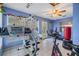 The home's exercise room includes tile flooring, workout equipment, and a ceiling fan at 2308 Rio Cir, Spring Hill, FL 34608