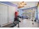 Home gym featuring tile flooring, ceiling fan, workout equipment, and natural light from a window at 2308 Rio Cir, Spring Hill, FL 34608