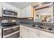 This kitchen features stainless steel appliances, granite countertops, and mosaic tile backsplash at 2308 Rio Cir, Spring Hill, FL 34608