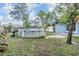 Exterior view of an above-ground pool with ladder in a well-maintained backyard with shed in distance at 2308 Rio Cir, Spring Hill, FL 34608