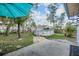 A concrete patio leads to an above-ground pool in the backyard surrounded by a wooden fence at 2308 Rio Cir, Spring Hill, FL 34608