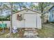 Exterior view of shed with access door, window with plants and mailbox at 2308 Rio Cir, Spring Hill, FL 34608