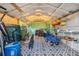 Interior view of shed with storage for tools and exercise equipment on patterned tile flooring at 2308 Rio Cir, Spring Hill, FL 34608