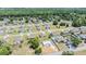 Aerial view of new construction home with surrounding neighborhood and wooded area at 27017 Mott Ave, Brooksville, FL 34602