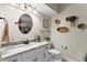Well-lit bathroom with a granite countertop vanity, modern fixtures, and neutral decor at 2933 W Alline Ave, Tampa, FL 33611