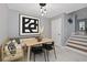 Bright dining area features a modern table, stylish seating, elegant light fixtures, and contemporary artwork at 2933 W Alline Ave, Tampa, FL 33611