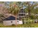 Rear exterior of the home showing a two-story screened porch and fenced yard at 2933 W Alline Ave, Tampa, FL 33611